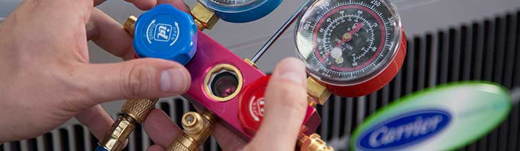 Service technician checking air conditioner for performance tests
