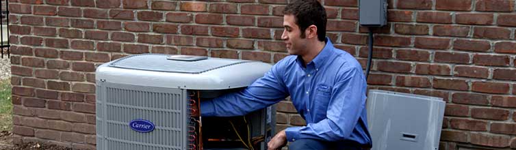 Service technician adjusting carrier unit