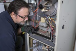 Vigilant Man Inspecting Furnace Shutterstock 323101256 E1506955293512