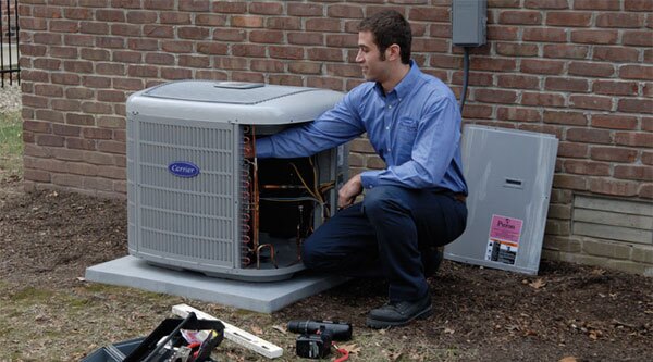 Technician working on air conditioner repair