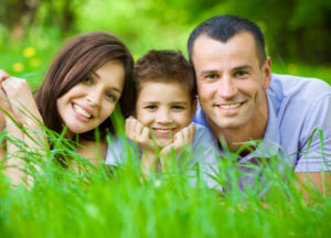 Asthma Family Of Three Lying On Grass Shutterstock 163441667