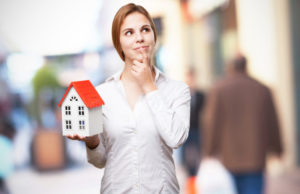 Pro Woman Thinking With Small House Shutterstock 277769858