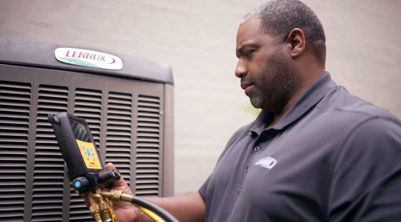 Technician working on air conditioner repair